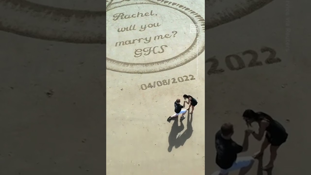 Man Proposes With Giant Ring Carved Into Sand
