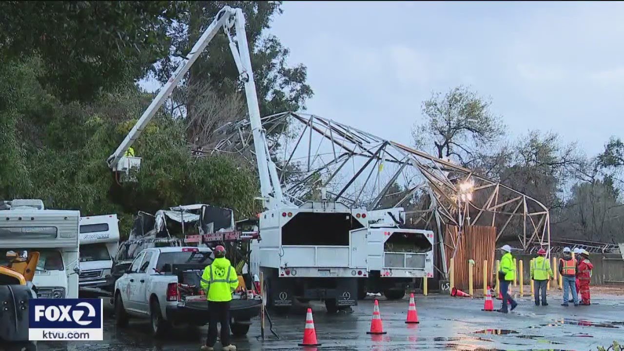 trees topple transmission tower