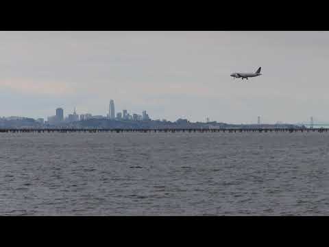 Hazy San Francisco Skyline And United Airlines Flight Landing At Sfo – California